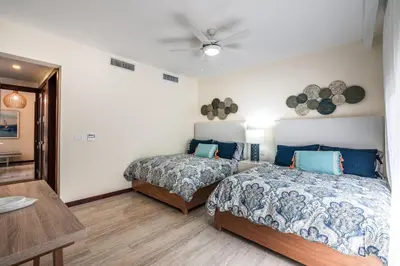 a bedroom with two beds and a table at 3BR apartment with balcony in Portillo - Terrenas in Abra Grande