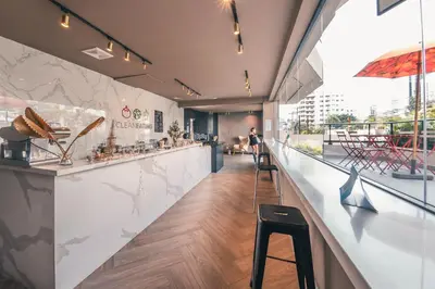 a restaurant with a counter and a bar with stools at Fully Serviced Apartment at Regatta Living II - 302 in Santo Domingo