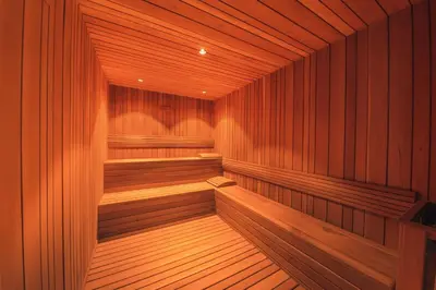 a large wooden sauna with wooden seats in it at Fully Serviced Apartment at Regatta Living II - 302 in Santo Domingo