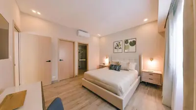 a bedroom with a bed and a desk in it at Fully Serviced Apartment at Regatta Living II - 304 in Santo Domingo