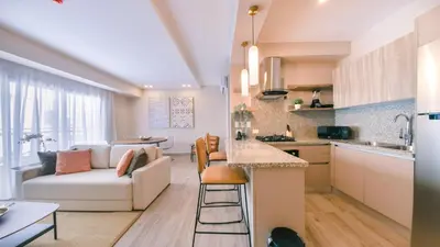 a kitchen and living room with a couch and a table at Fully Serviced Apartment at Regatta Living II - 304 in Santo Domingo