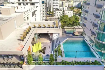 an aerial view of a building with a swimming pool at Fully Serviced Apartment at Regatta Living II - 907 in Santo Domingo