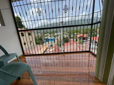 a room with a balcony with a view of a pool at Oasis de paz 2 in Jarabacoa