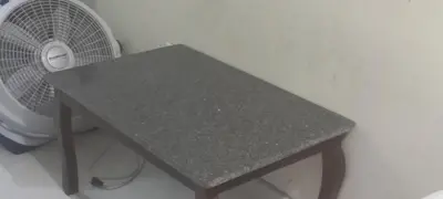 a gray table with a fan next to a wall at Cozy Guest Room in Santo Domingo Este with Private Entrance in La Viva