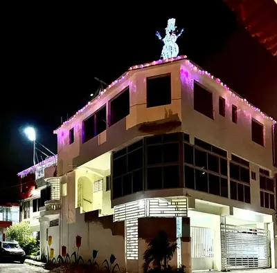 a building with purple lights on top of it at Hotel Maria Bonita Higüey in Higuey