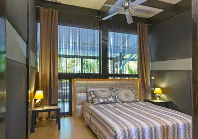 a bedroom with a bed and a large window at Chaykovski Boutique H in Las Terrenas