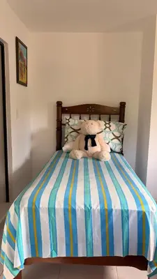 a teddy bear sitting on top of a bed at Great location, right downtown Puerto plata . in San Felipe de Puerto Plata