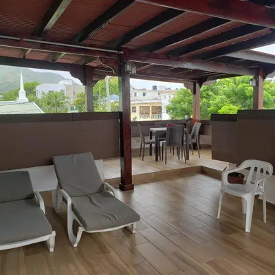 a patio with chairs and a table on a roof at Great location, right downtown Puerto plata . in San Felipe de Puerto Plata