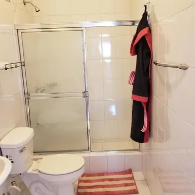 a bathroom with a toilet and a glass shower at Great location, right downtown Puerto plata . in San Felipe de Puerto Plata