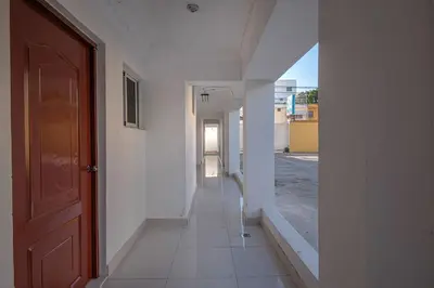 an empty hallway of a building with a door at Double Room, Corales del SurOle Las Americas- Isabelita - Aeropuerto-Aeropuerto in La Viva