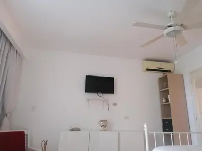 a living room with a tv on a white wall at Apartment Monocal in Boca Chica in Boca Chica
