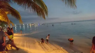 a group of people on a beach near the water at Apartment Monocal in Boca Chica in Boca Chica