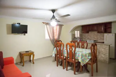 a dining room with a table and chairs and a tv at 2 Bedroom 2 Bathroom Apartment- Corales del Sur Ole Las Americas- Isabelita in La Viva