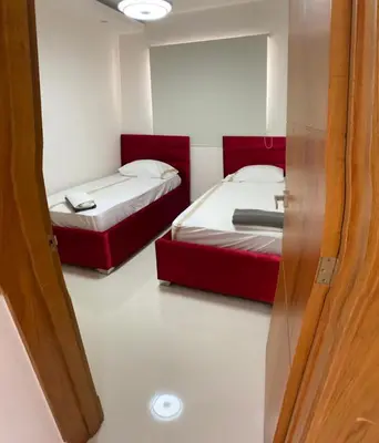 a room with two beds and a sliding door at Verdana SFM A2 in San Francisco de Macorís