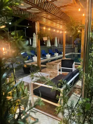a patio with couches and chairs under a pergola at Verdana SFM A2 in San Francisco de Macorís