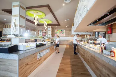 a group of people standing at the counter of a restaurant at Riu Republica - Adults Only - All Inclusive in Punta Cana