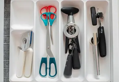 a white container with scissors and other kitchen utensils at Escape Apartments, Balcony, Pool, Gym & Spa in La Julia in Santo Domingo
