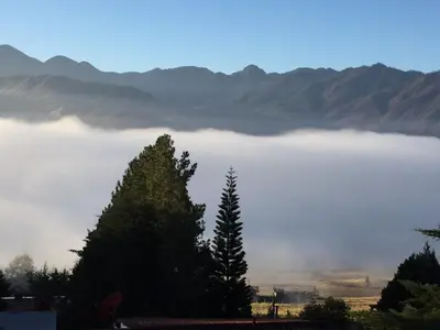 a view of a foggy lake with mountains in the background at Villa Paloma/ Home/ Office-Remote Office in Constanza