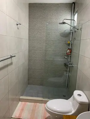 a bathroom with a glass shower with a toilet at Furnished Apartment - Residencial Olas - Gated Community - 24 hr Security in San Felipe de Puerto Plata