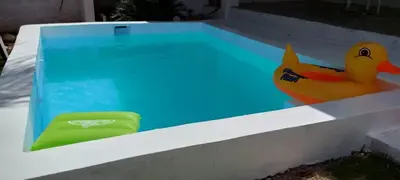 a swimming pool with a rubber duck toy in it at Apartamento Los Blancos, a dos Minutos de los Patos Barahona in Enriquillo
