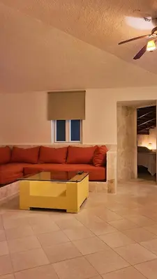 a living room with a red couch and a yellow coffee table at Tritón Hotel Boutique & Restaurant in Guayacanes