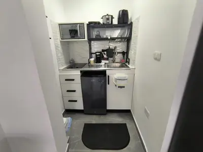 a small kitchen with a sink and a stove at La casita de Gazcue in Santo Domingo