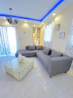 a living room with a couch and a table at Cozy Apartment RM in Santiago de los Caballeros