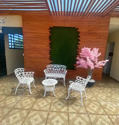 a group of chairs and a table and a plant at Cozy Apartment RM in Santiago de los Caballeros