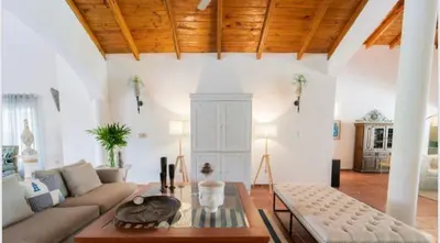 a living room with a couch and a table at Lux Villa Casa de Campo in La Romana