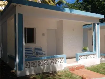 a house with a large mirror on the front of it at Bungalow #1 at Waterfront Playa Alicia in Sosúa