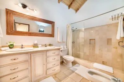 a bathroom with a toilet sink and a shower at Los Lagos 19 - Sleeps 10 - Butler - Pool Hot Tub in La Romana