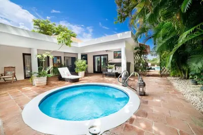 a hot tub in a yard with a house at Los Lagos 19 - Sleeps 10 - Butler - Pool Hot Tub in La Romana