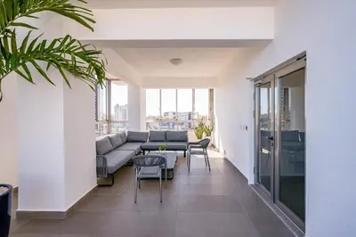 a living room with a couch and a table and chairs at Apartments in La Julia 1 and 2 Bedrooms in Santo Domingo