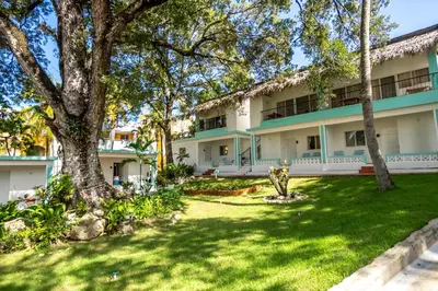 an exterior view of a building with trees at Bungalow #10 at Waterfront Playa Alicia in Sosúa