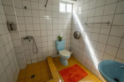 a bathroom with a toilet and a sink at Bungalow #16 at Waterfront Playa Alicia in Sosúa