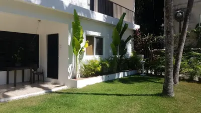 a garden outside a house with a grass yard at Apartment #21 at Waterfront Playa Alicia in Sosúa
