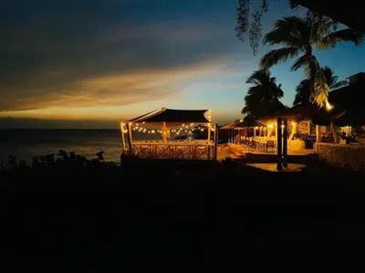 a gazebo with lights on the beach at night at Bungalow #3 at Waterfront Playa Alicia in Sosúa