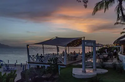 a wedding reception at the beach at dusk at Bungalow #7 at Waterfront Playa Alicia in Sosúa