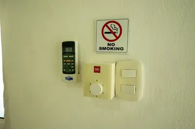 a no smoking sign and a no smoking sign on a wall at Bungalow #9 at Waterfront Playa Alicia in Sosúa