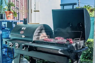 a grill with meat cooking on top of it at Villa Nilsa ( The Blue House ) in Baní