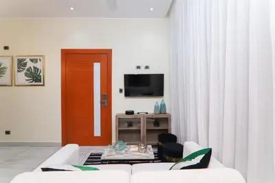a living room with a white couch and a television at N1401 Espectacular vista Downtown Santo Domingo RD in Santo Domingo