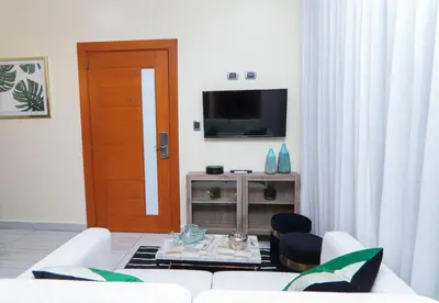 a living room with a couch and a tv at N1401 Espectacular vista Downtown Santo Domingo RD in Santo Domingo