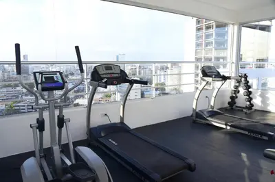 two tread machines in a gym with a view of a city at N1401 Espectacular vista Downtown Santo Domingo RD in Santo Domingo