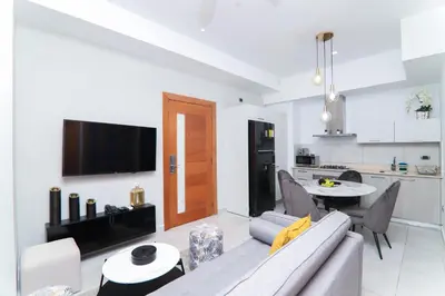 a living room with a couch and a table and a kitchen at S1401 La mejor vista Downtown Santo Domingo RD in Santo Domingo