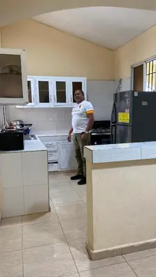 a man is standing in a kitchen at TriRoom Apartment SANTO DOMINGO ESTE in Santo Domingo