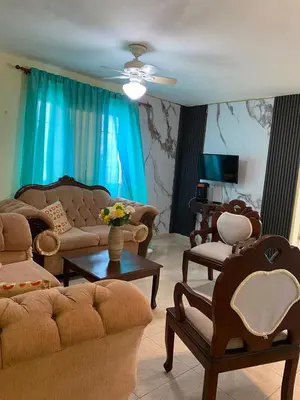 a living room with couches and chairs and a table at TriRoom Apartment SANTO DOMINGO ESTE in Santo Domingo