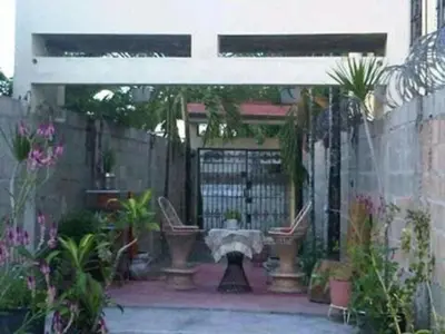 a patio with a gate and some plants at Villa Julirous Rd 2 bedrooms apartment in Boca Chica