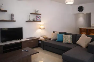 a living room with a couch and a flat screen tv at Estudio Frente al Mar Solo Adultos in La Laguna