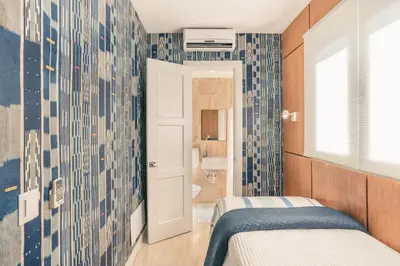 a small bedroom with a bed and a bathroom at Newly Added El Portillo 2BR Apt in Abra Grande