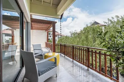 a balcony with chairs and a view of trees at Newly Added El Portillo 2BR Apt in Abra Grande